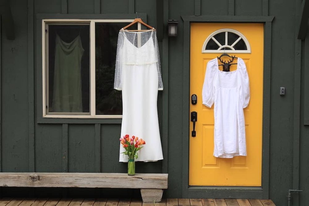 wedding dresses hanging in a window