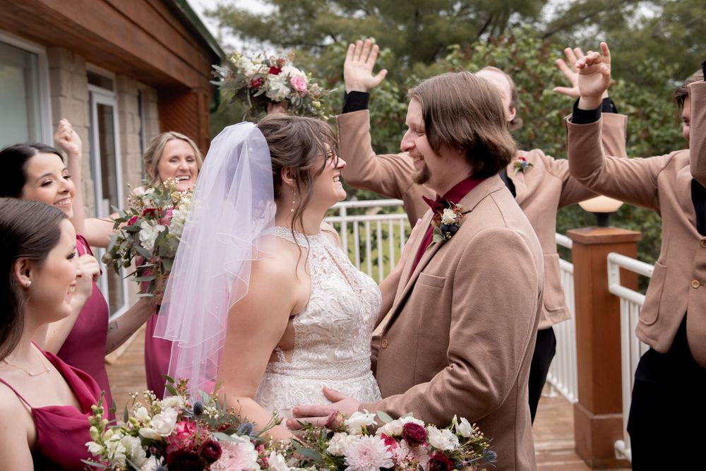 Wedding celebration on outdoor deck with joyful gathering.