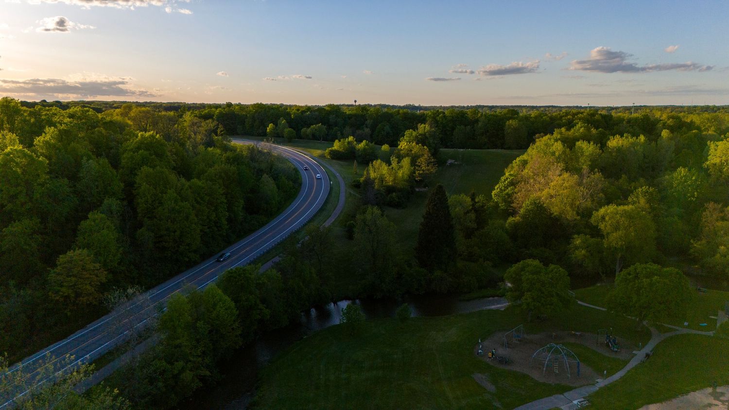 An aerial image of a sunset over a road