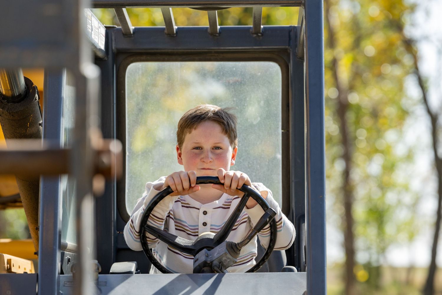 Students wearing masks look out windows of a yellow school bus during the pandemic.