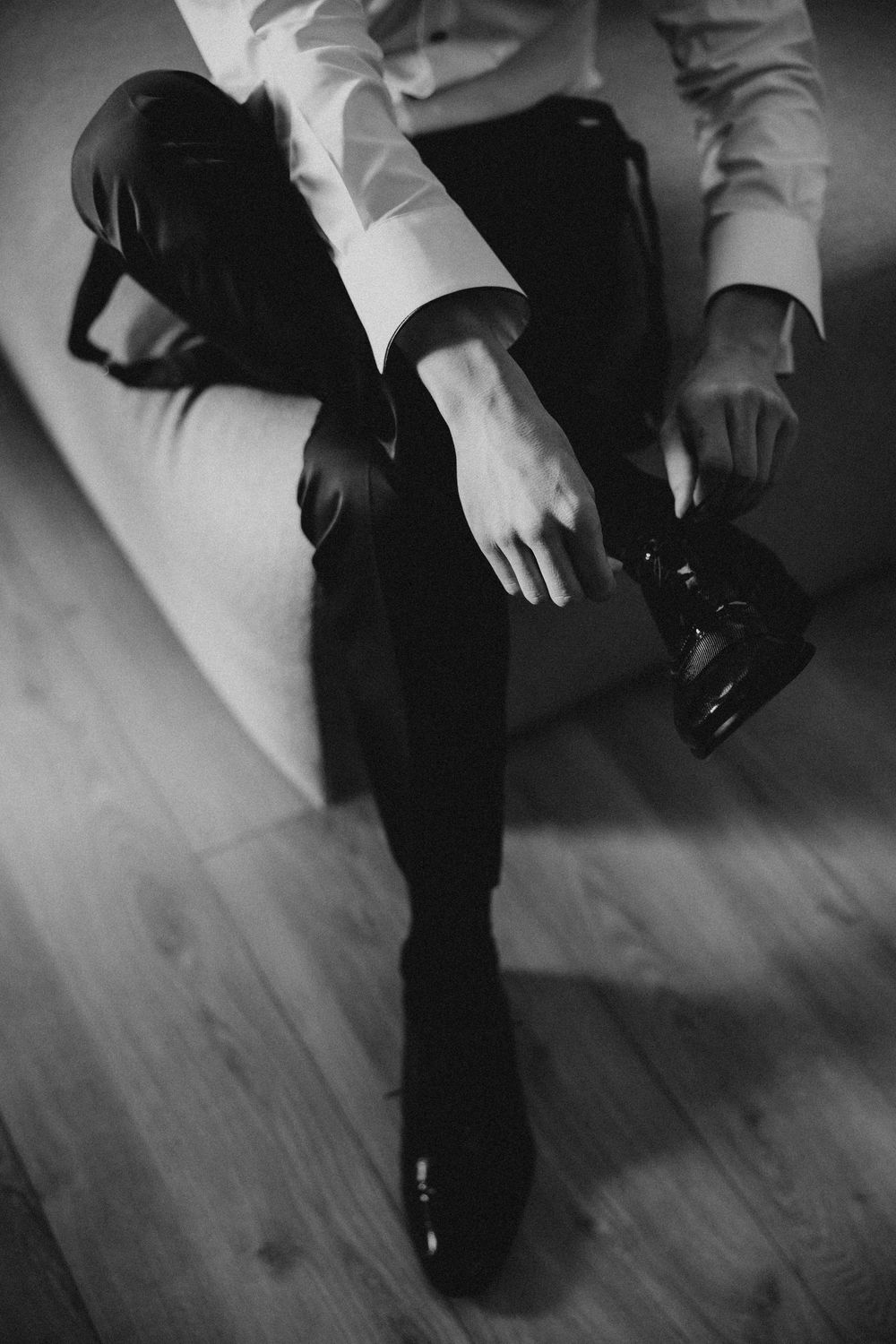 Black and white artistic series of dance shoes in motion on a wooden floor during a performance.