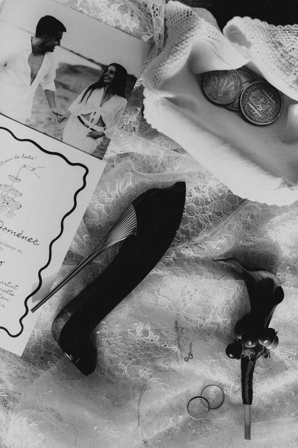 Black and white artistic photographs of paper documents and objects arranged in an abstract composition on a textured surface.