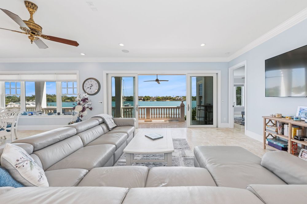 real estate photography of Intacoastal view with Spacious open-concept living room with large windows and cozy seating in Jupiter home
