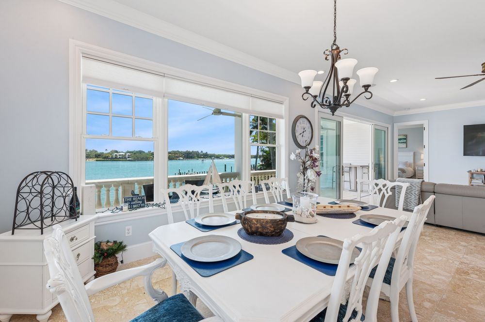 real estate photography of Intacoastal view with Spacious open-concept living room with large windows and cozy seating in Jupiter home