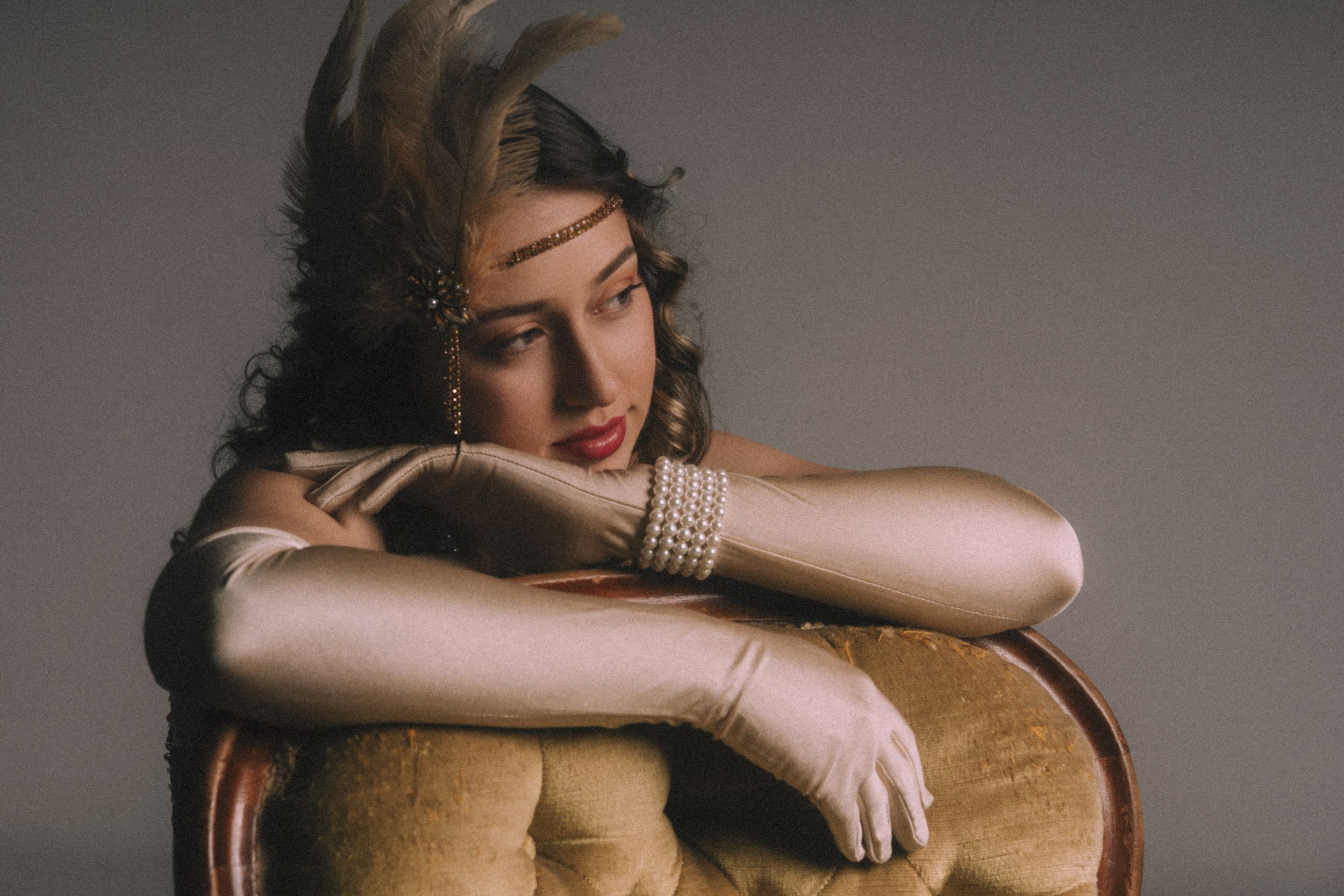 A series of vintage-style photographs showing a person posing with a brown leather chair in different artistic positions.