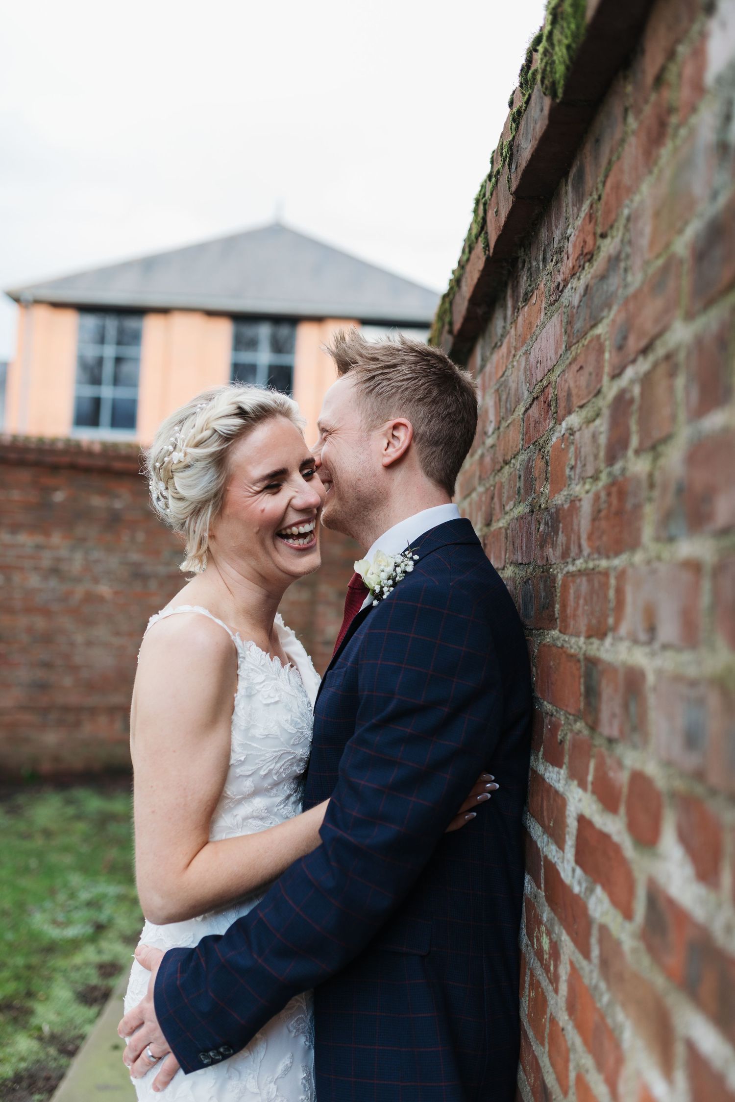 Romantic wedding couple embracing against rustic brick wall. Photographer. Hull. East Yorkshire. Photography