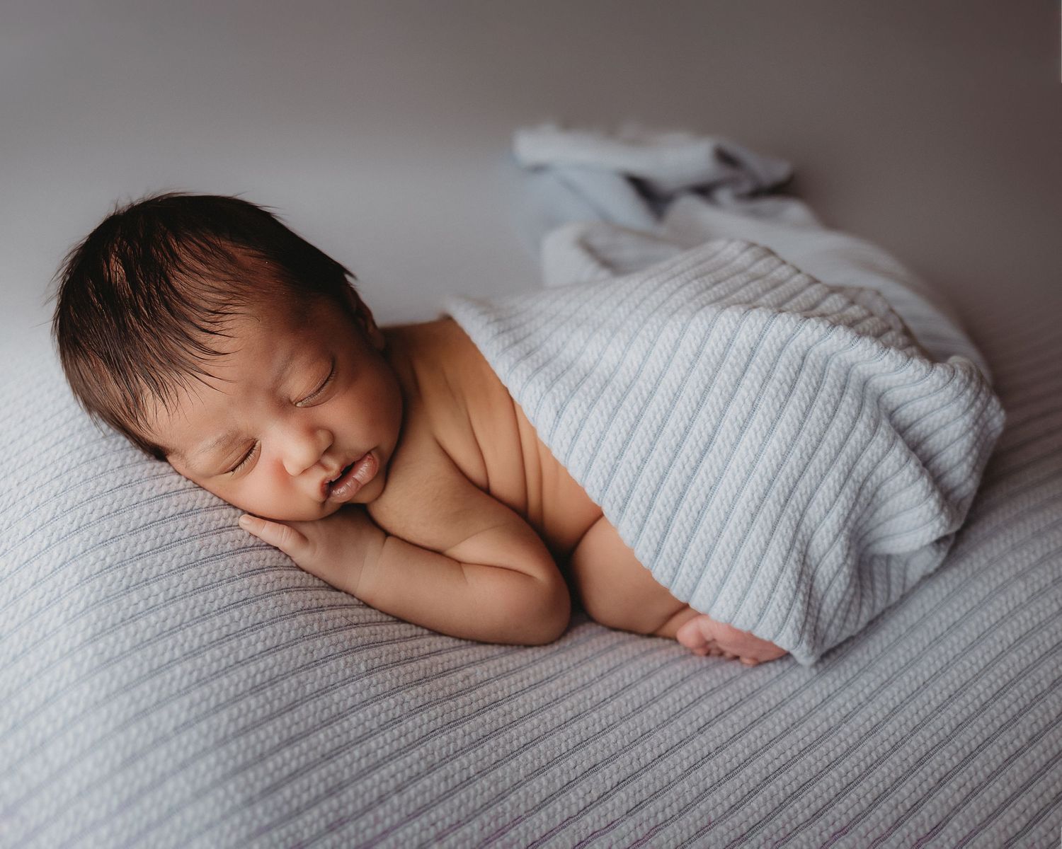 Professional photo of a newborn baby sleeping