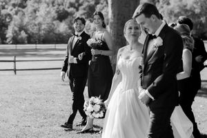 Black and white wedding ceremony moment captured outdoors.