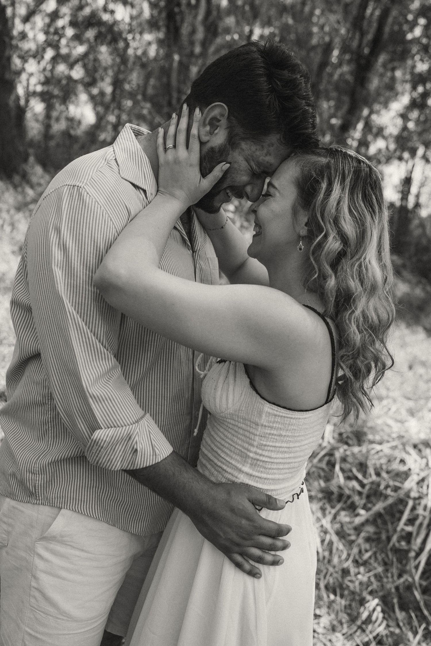 Series of intimate black and white photos showing couple's tender moments in nature.