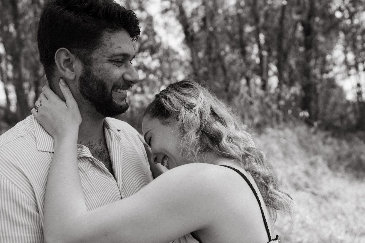 Monochrome photo strip showing couple's loving moments in outdoor setting.