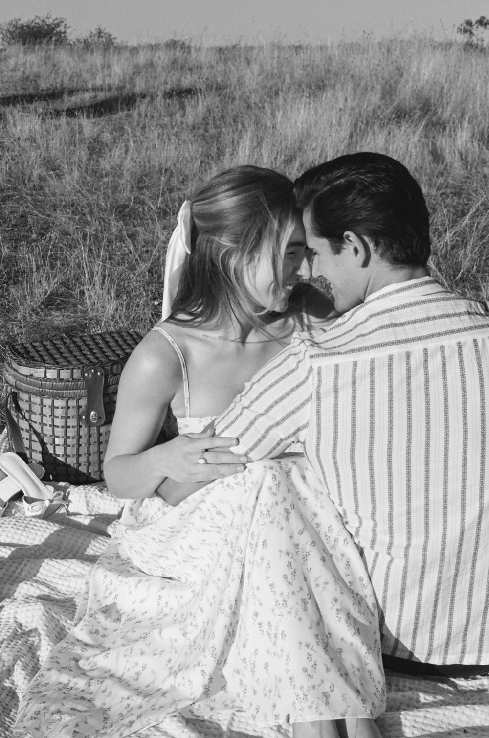 Black and white sequence showing two people resting together on blankets outdoors.