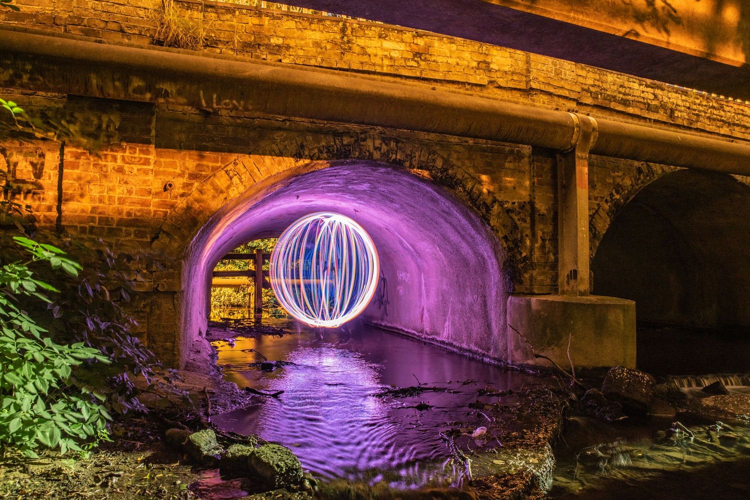 Light Painting under a bridge, image created using an orb tool and a method called spinning