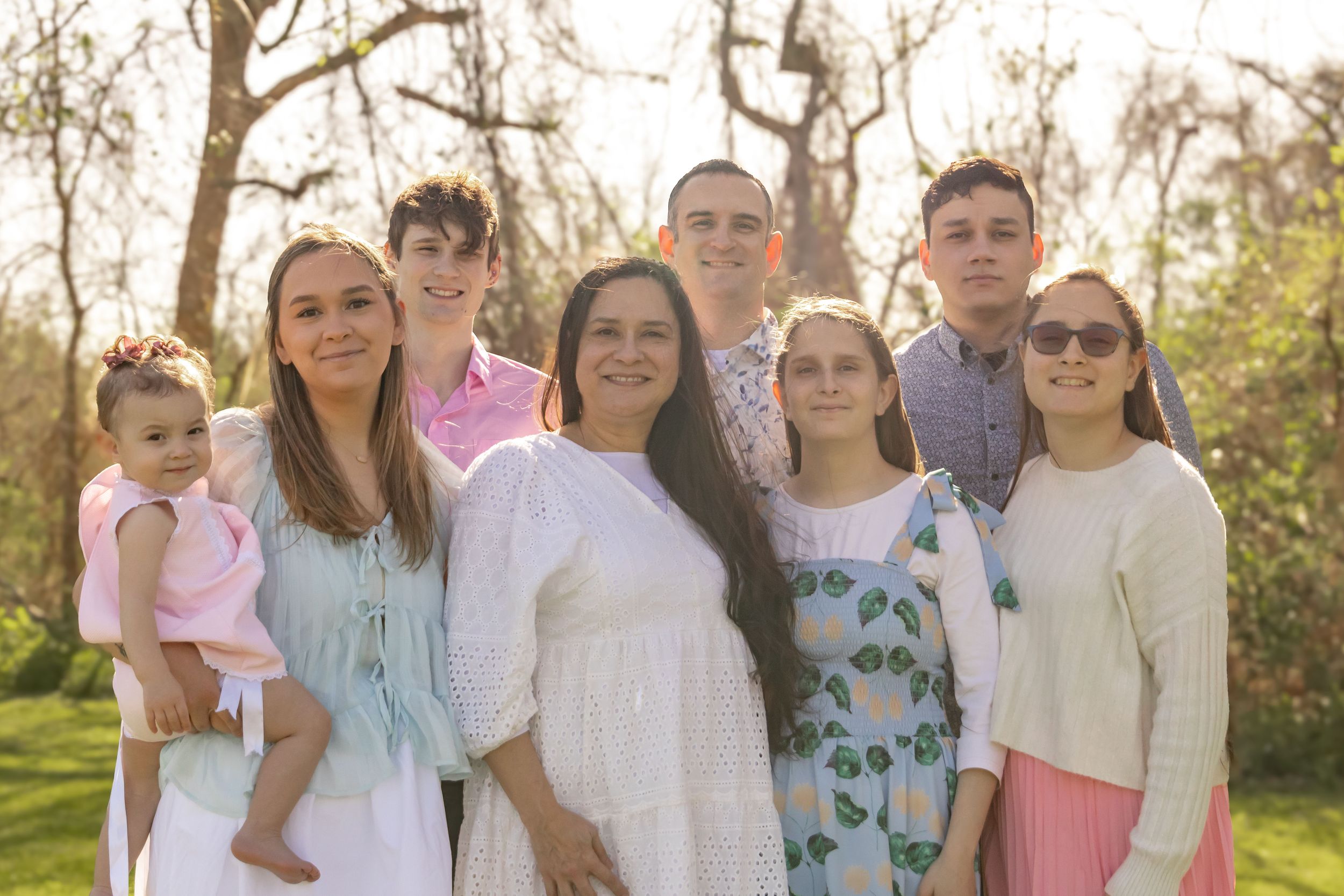 Family of eight pose for family photos in Sugar Land, Texas.