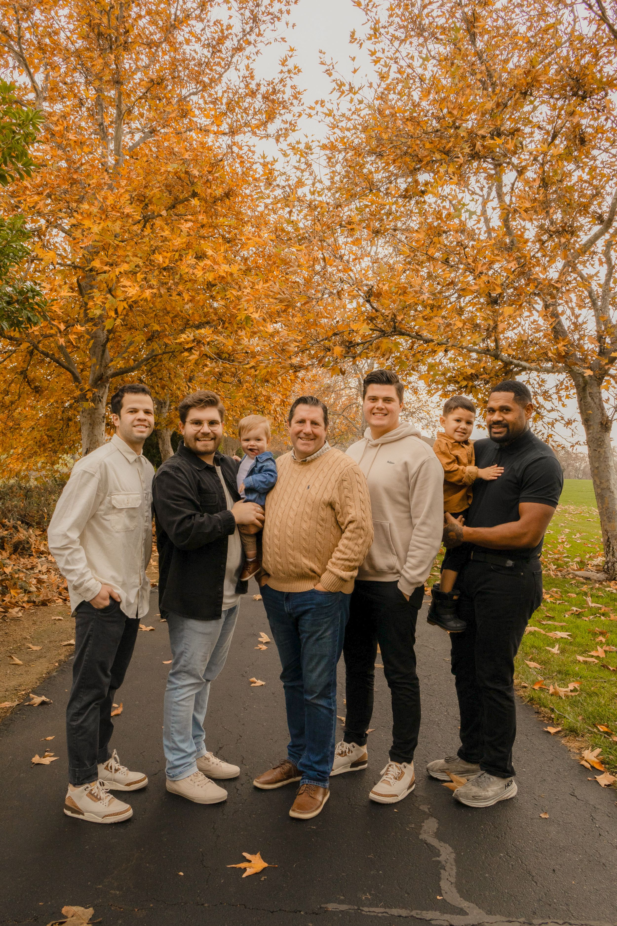 All the boys in an extended family photo session with fall leaves.