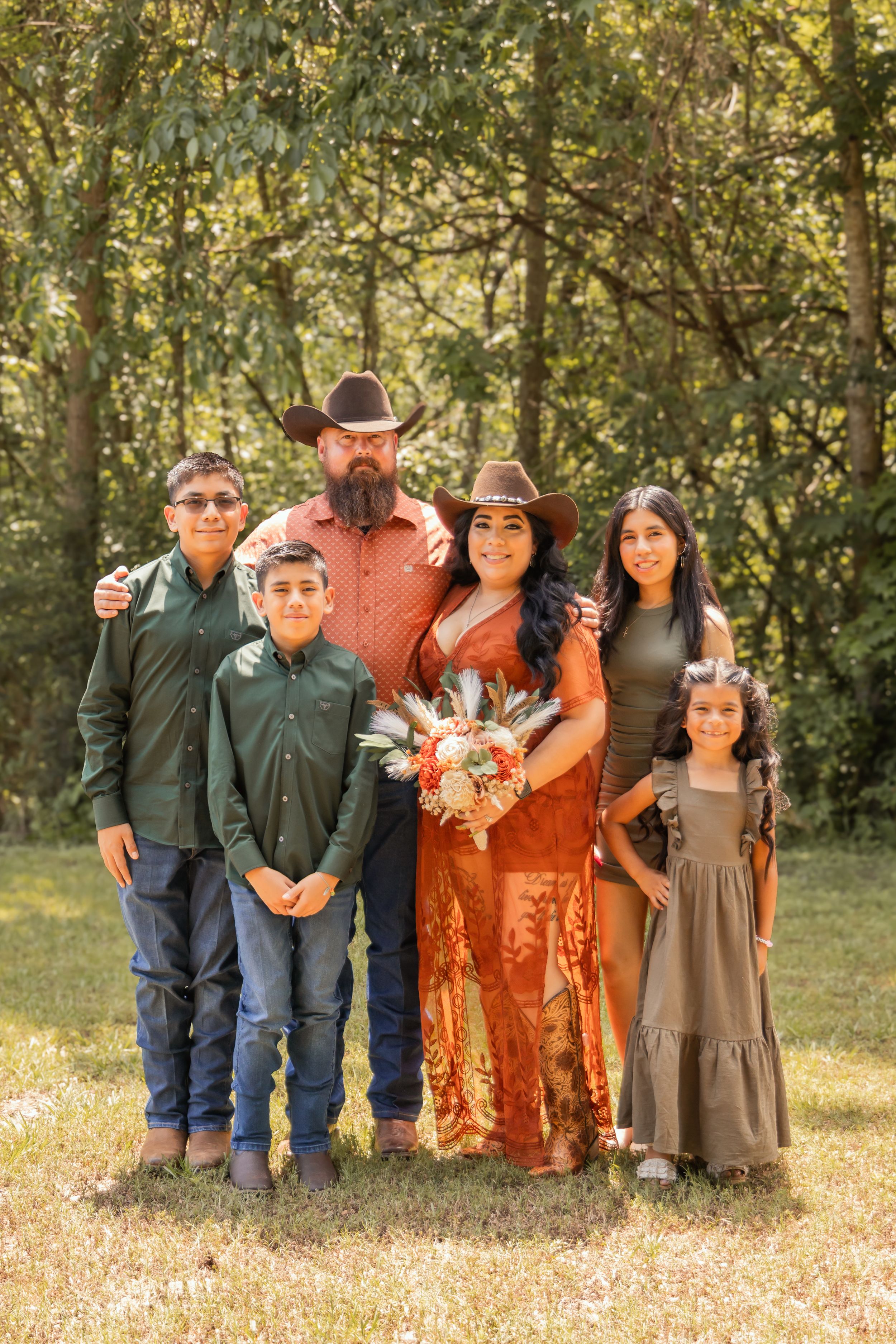 Family of six posing at their parent's wedding in Houston, Texas.
