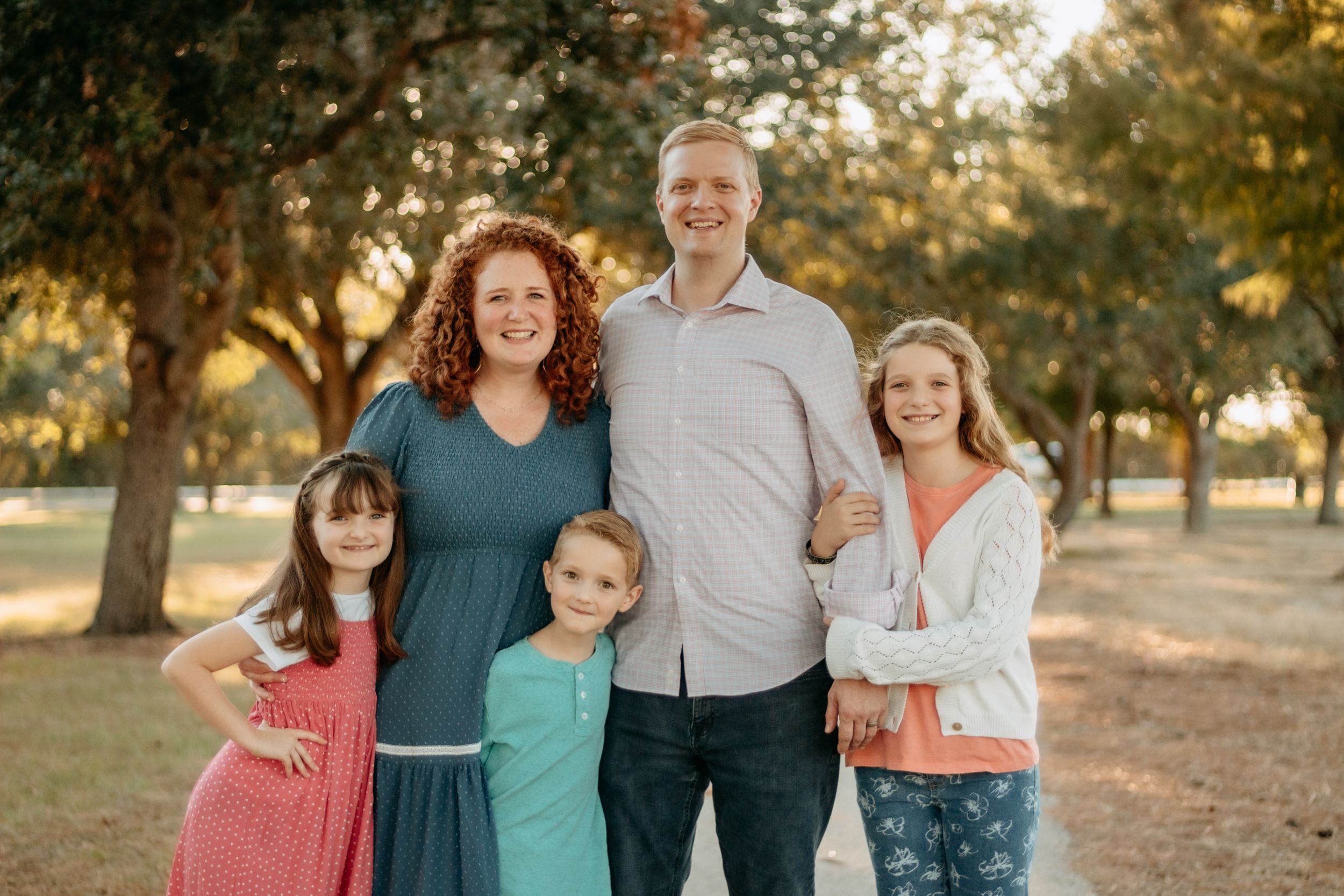 Family of five pose for a family photo in a park in Cypress, Texas.