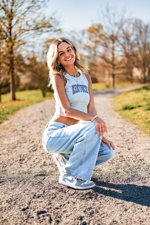 A series of casual outdoor portrait shots taken on a dirt path with autumn trees in the background.
