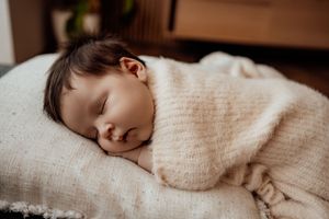 Peaceful naptime scene with soft natural lighting and cozy blankets.