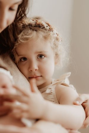 Ethereal portrait of toddler with floral crown in soft natural light.