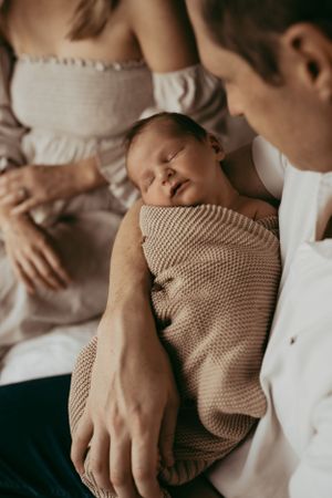 Intimate family moment captured in soft muted tones.
