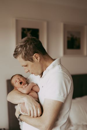 Tender moments between parent and newborn in natural light.