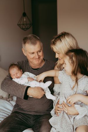 Sweet family moment on a couch with gentle touches and snuggles.