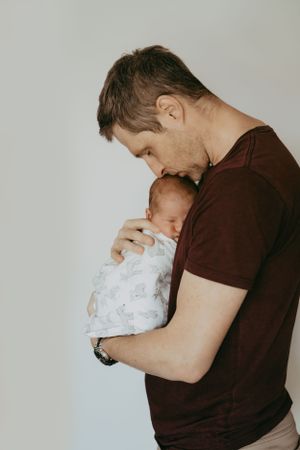 Intimate black and white portrait capturing tender moments between parent and infant.