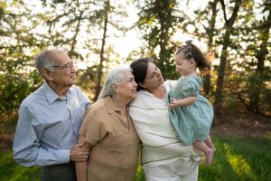 Multi-generational family portrait captured outdoors in natural lighting.