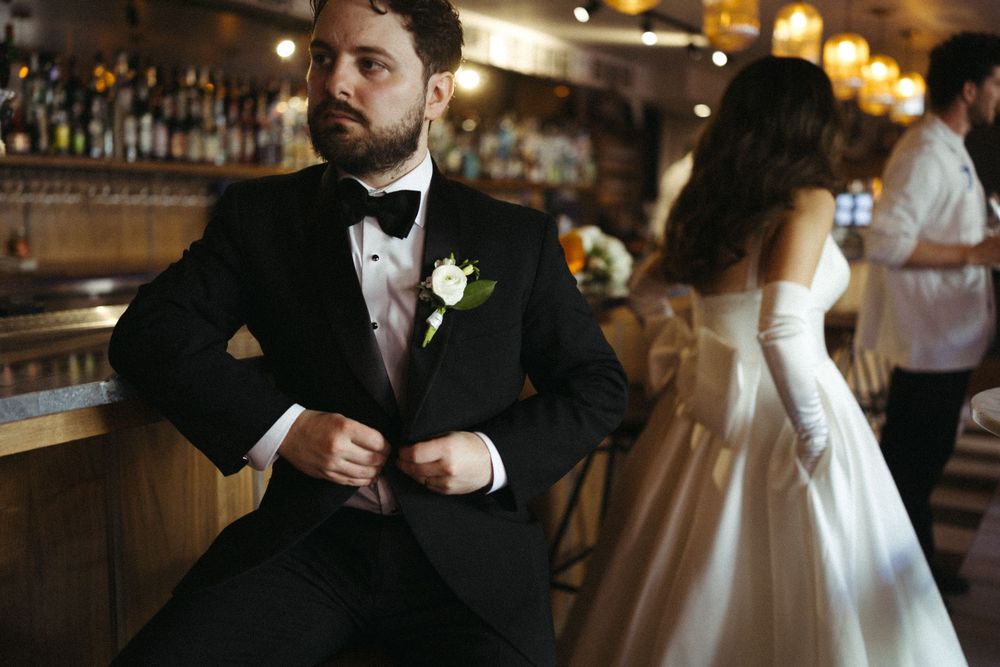 A row of candid wedding reception moments showing guests and couples mingling at a dimly lit bar area.