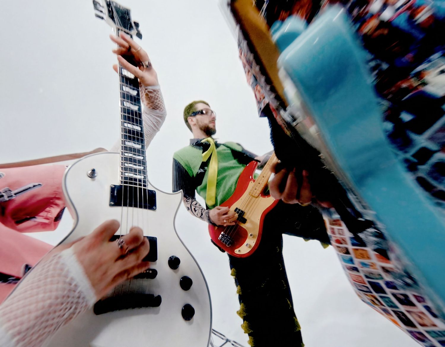 Live music concert photography of two guitarists playing electric guitars, low angle shot with colorful stage lighting