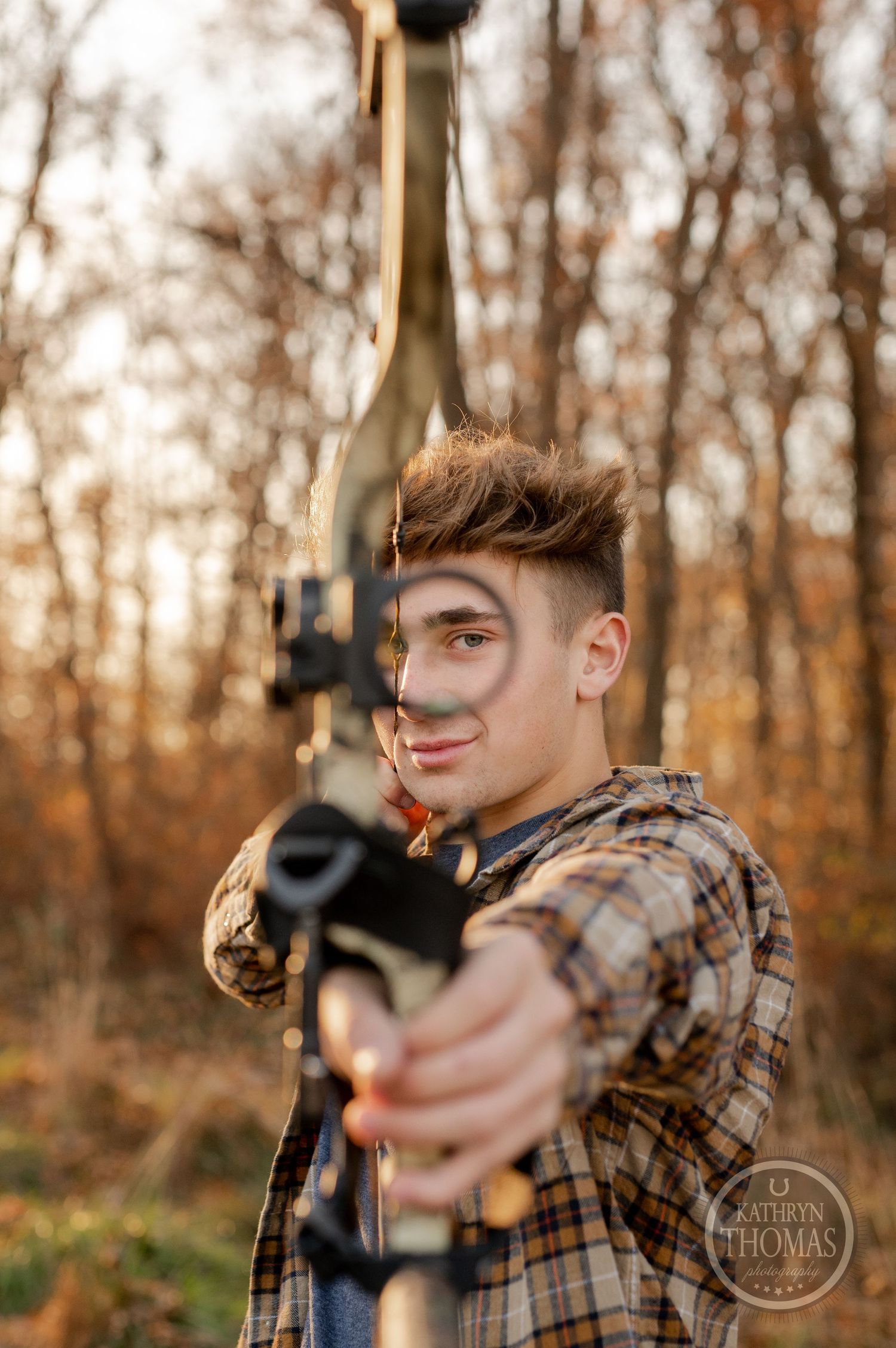 Close-up shot of archer aiming compound bow in woodland setting.