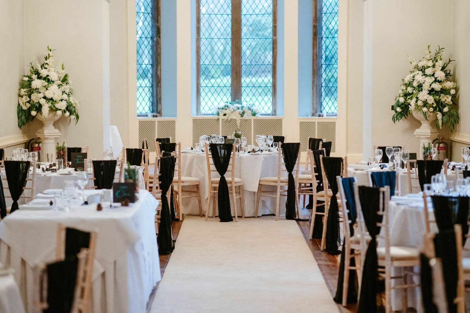Clearwell Castle wedding venue Gloucestershire castle Lanscape of wedding breakfast room wih black and white theme