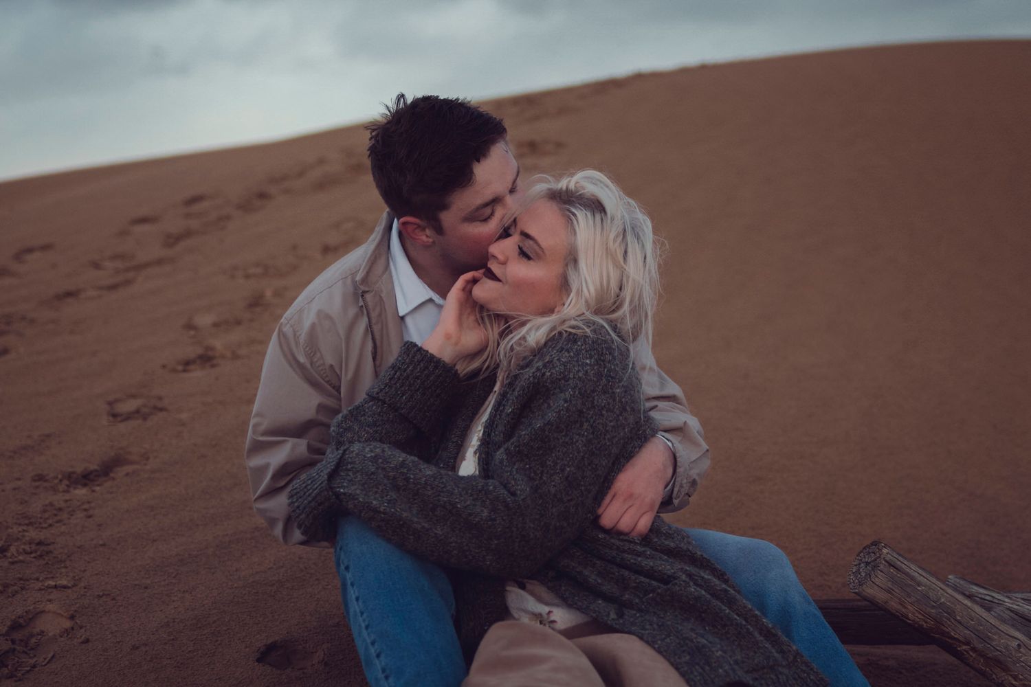 Visiting couple explore sand dunes during a shoulder season spring day date couples portrait session near Kingston Ontario