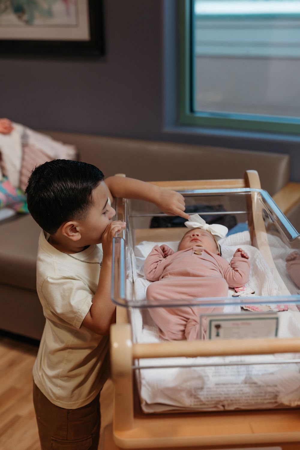 brother with newborn baby during a Fresh 48 hospital session