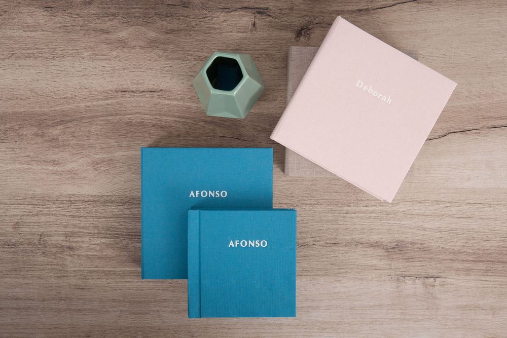 Multiple blue and white boxes arranged in a minimalist layout on light wood grain surface.