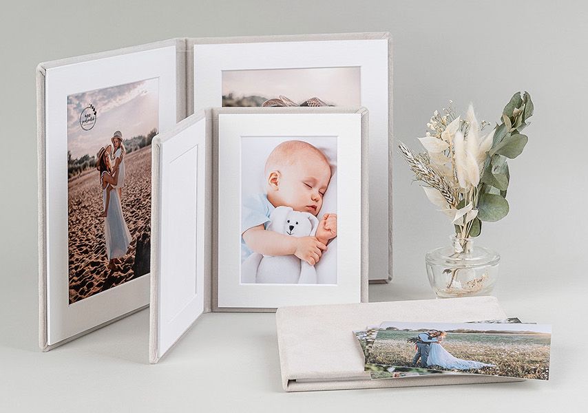 A collection of white framed photos displayed in a horizontal row showing various artistic portraits and scenes.