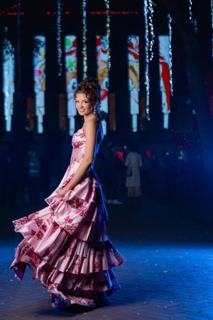High school senior in floral pink prom dress posing for Charleston SC prom portrait photography at night