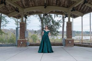 Senior prom portrait session featuring high school student in emerald gown photographed in Charleston South Carolina