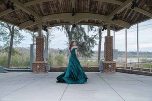 High school senior prom portraits photographed in Charleston SC park with elegant emerald formal gown