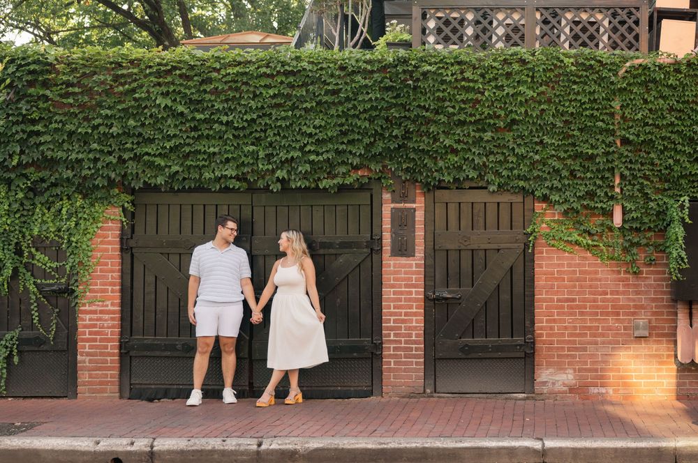 A series of connected photos showing a couple walking through a brick-lined garden pathway at sunset. German Village Engagement session