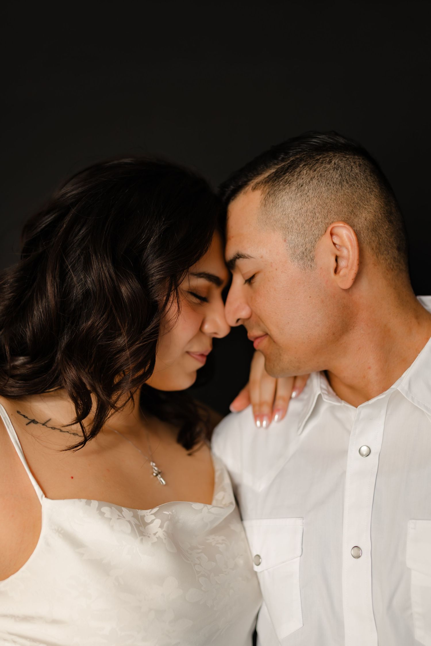 A romantic series of intimate close-up shots showing a couple in white clothing sharing tender moments together.