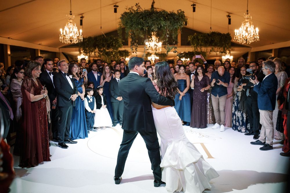 Bride and groom first dance surrounded by guests at luxury Indian wedding reception in Lisbon, portugal