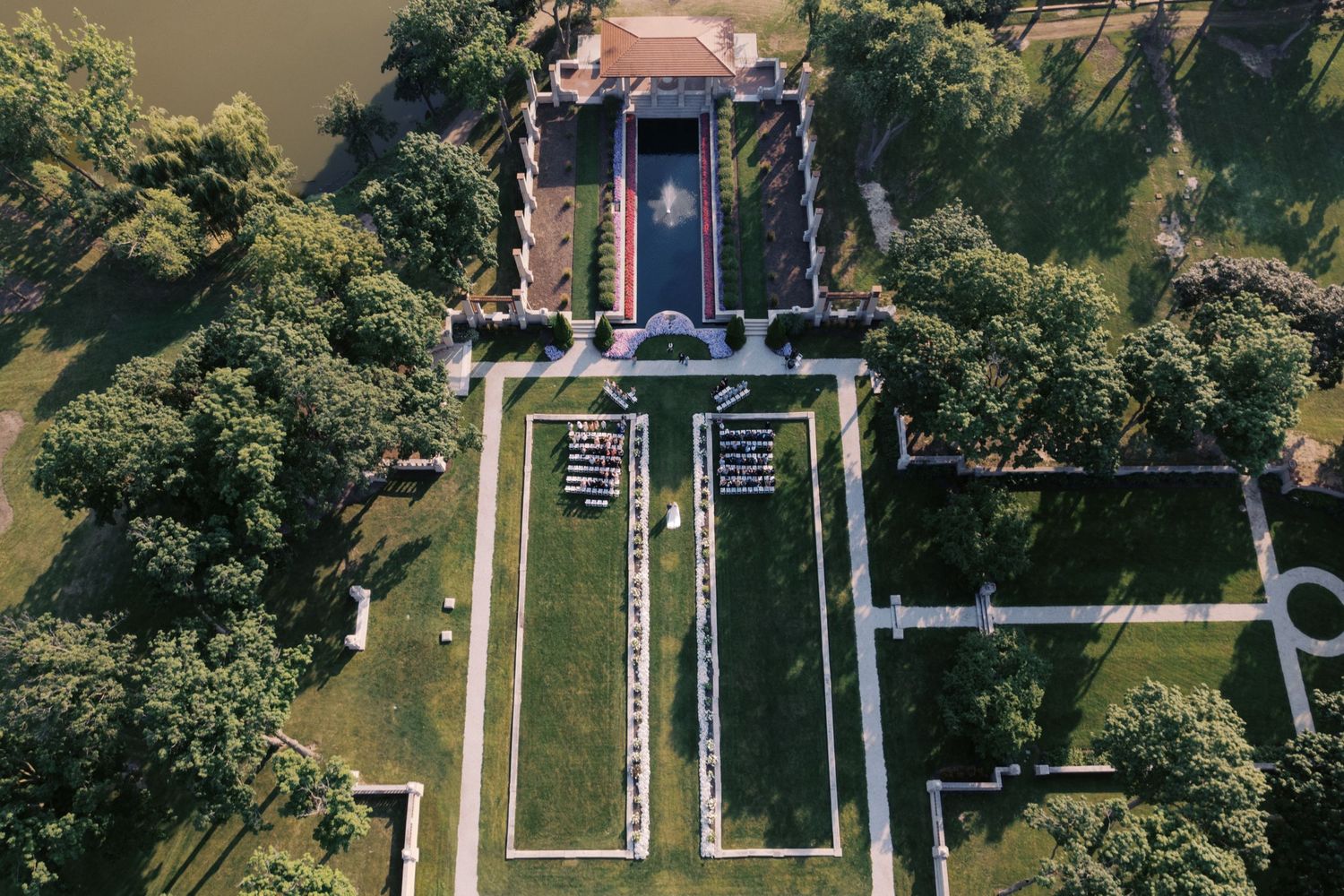 Aerial view of a historic church and cemetery with well-maintained pathways and green landscaping.