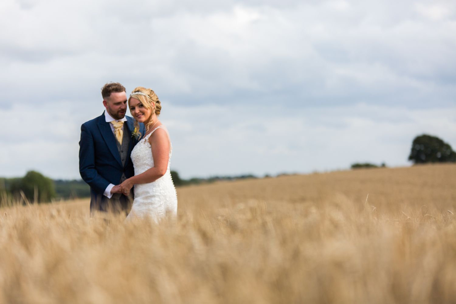 Elegant nighttime wedding photography at a historic brick venue illuminated by warm amber lighting and architectural details.