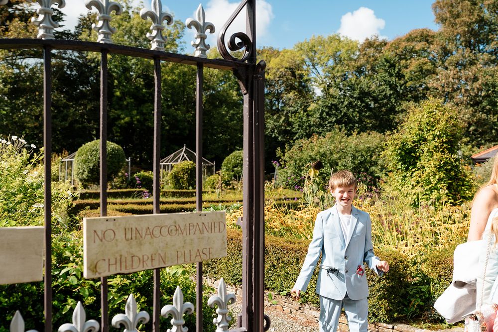 A series of outdoor wedding photos showing a couple walking through a scenic garden path with trees and sunlight.