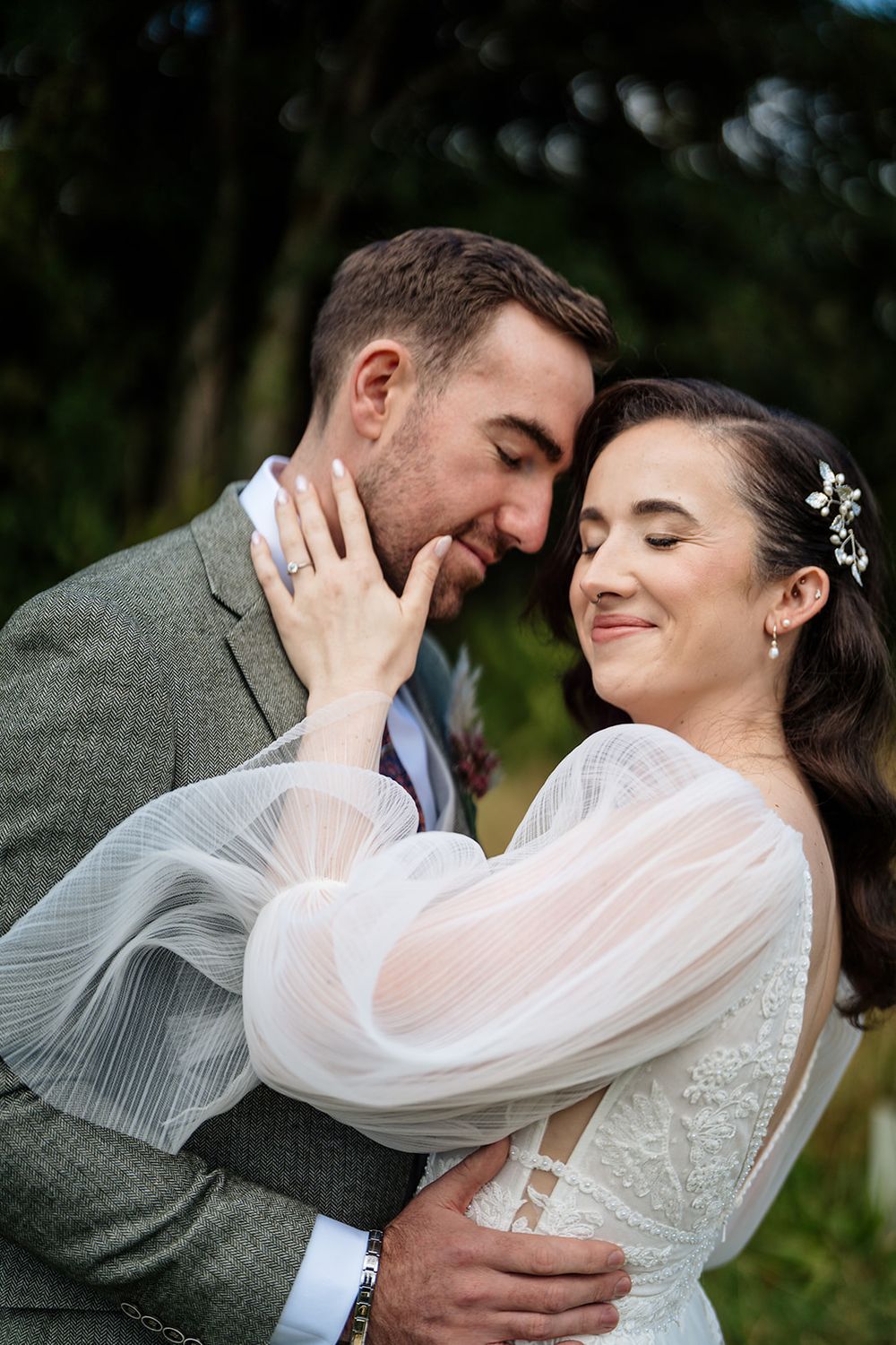 A romantic wedding couple shares intimate moments in a series of outdoor portrait photographs.