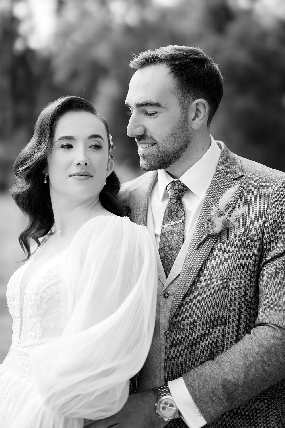 A romantic black and white photo series showing a couple in wedding attire sharing intimate moments together.