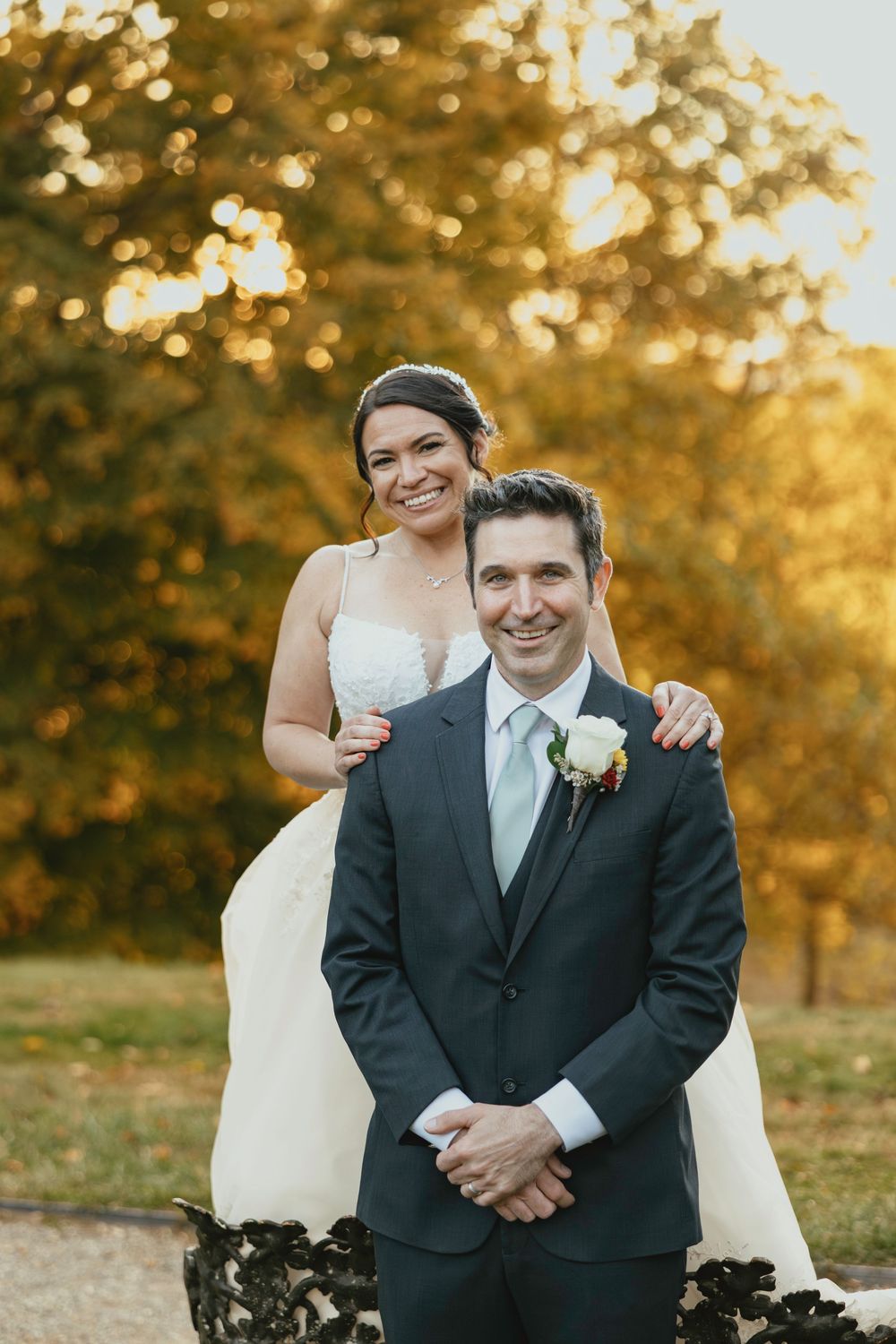Wedding couple shares intimate moments during golden hour sunset in outdoor autumn setting.