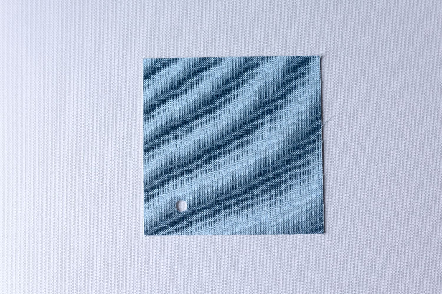 A square piece of olive green fabric or material against a white background.