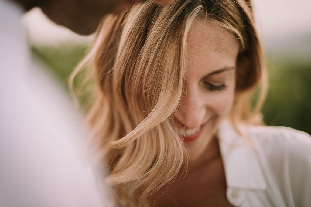 A bride and groom share an intimate moment during their outdoor wedding celebration.